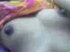 A really attractive and natural Hindu brunette shows off her breasts while giggling.